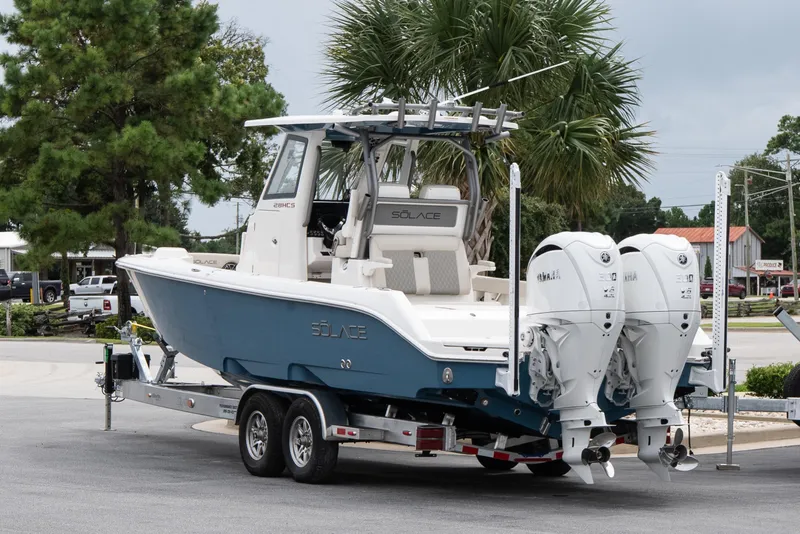 Slide: The Image of 2026 Solace 28 HCS boat on trailer, featuring dual engines, parked outdoors. - 5