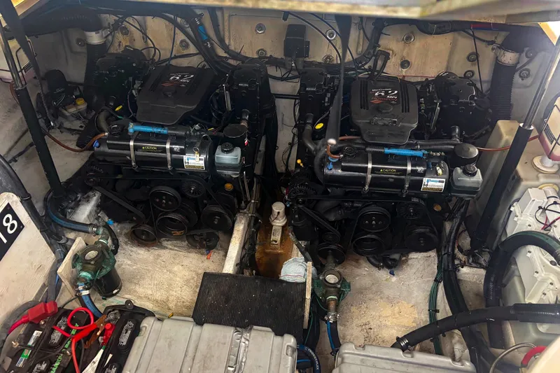 Slide: The Image of Engine room of a 2006 Sea Ray 320 Sundancer with dual motors and mechanical components. - 10