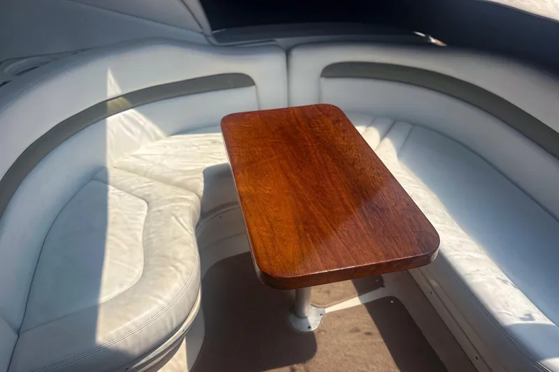 Slide: The Image of Interior seating area of 2006 Sea Ray 320 Sundancer with wooden table. - 7