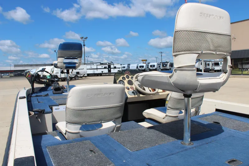 Slide: The Image of 1997 Crestliner 1750 Tournament Pro boat interior with seats and steering wheel, parked outdoors. - 11