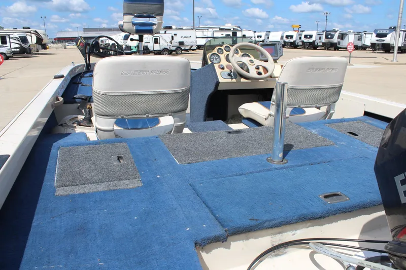 Slide: The Image of 1997 Crestliner 1750 Tournament Pro boat interior with blue carpet and dual seats. - 13