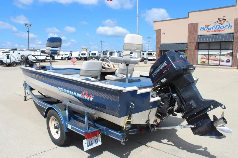 Slide: The Image of 1997 Crestliner 1750 Tournament Pro boat with Evinrude motor at dealership. - 2