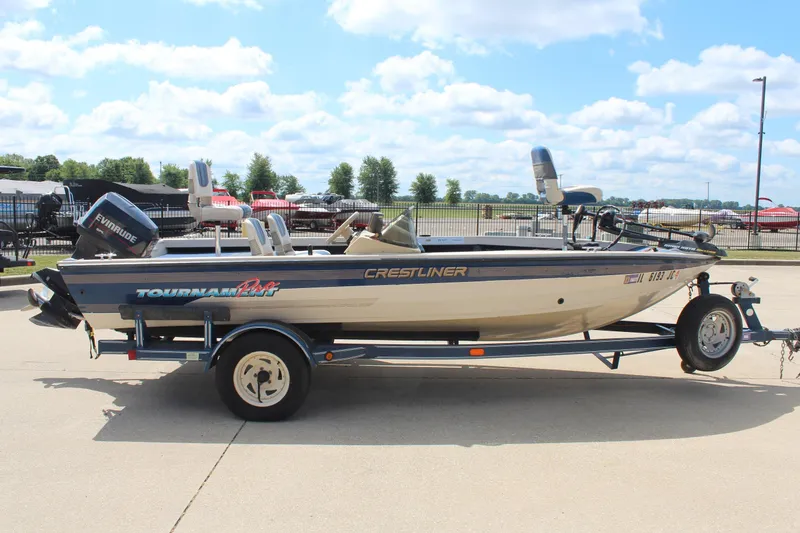 Slide: The Image of 1997 Crestliner 1750 Tournament Pro boat on trailer, parked outdoors under a blue sky. - 5