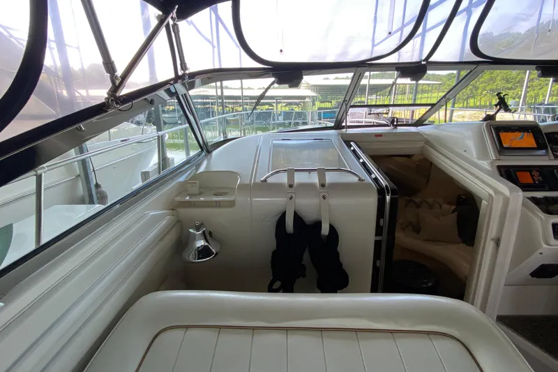 Slide: The Image of 1997 Sea Ray 400 Express Cruiser cockpit with navigation equipment and seating. - 11