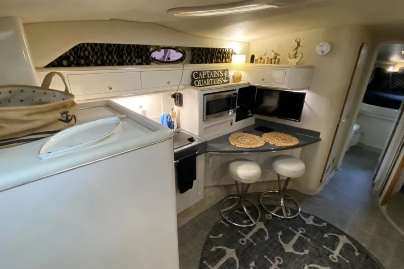 Slide: The Image of Interior of 1997 Sea Ray 400 Express Cruiser with modern kitchen and seating area. - 14