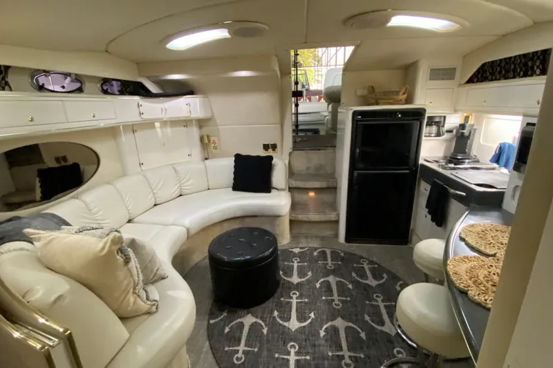 Slide: The Image of Luxurious 1997 Sea Ray 400 Express Cruiser interior with white leather seating and modern kitchen amenities. - 19
