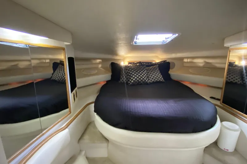 Slide: The Image of Luxurious cabin interior of 1997 Sea Ray 400 Express Cruiser with cozy bed and mirrors. - 22
