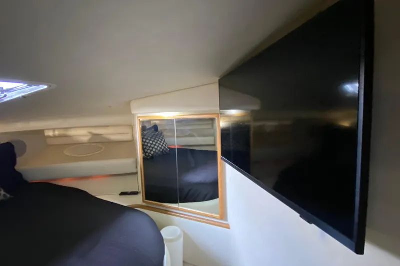 Slide: The Image of Interior cabin of 1997 Sea Ray 400 Express Cruiser with TV and mirror. - 23