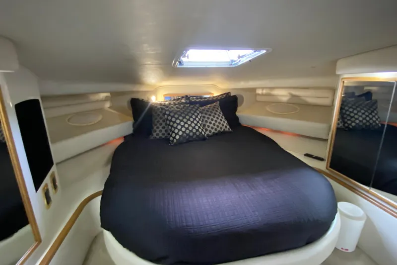 Slide: The Image of 1997 Sea Ray 400 Express Cruiser cabin with cozy bed and stylish decor. - 24