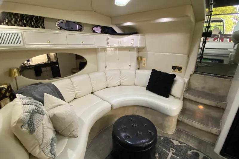 Slide: The Image of 1997 Sea Ray 400 Express Cruiser interior with white leather seating and modern decor. - 25