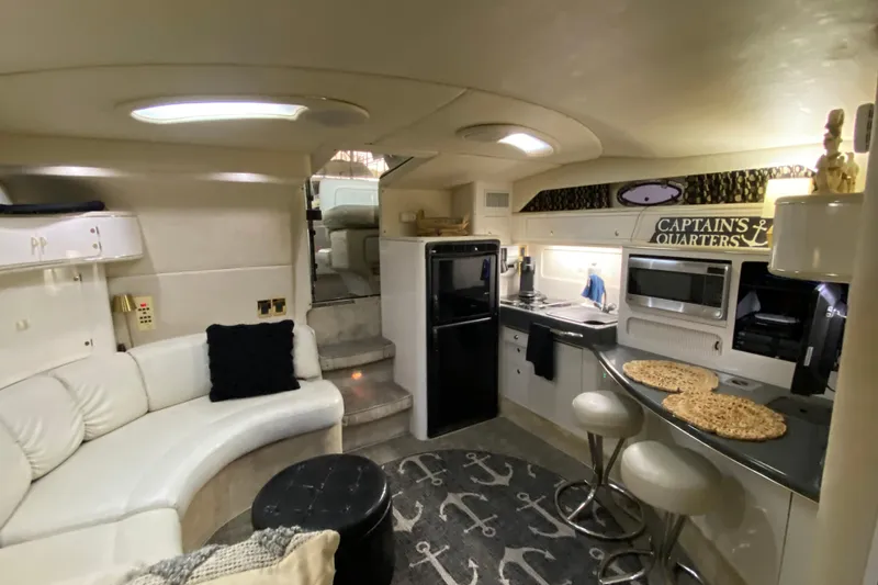 Slide: The Image of Interior of 1997 Sea Ray 400 Express Cruiser with modern kitchen and cozy seating area. - 26