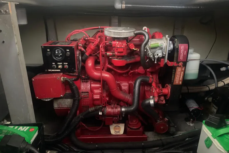 Slide: The Image of Engine of a 1997 Sea Ray 400 Express Cruiser, featuring red components and control panel. - 33