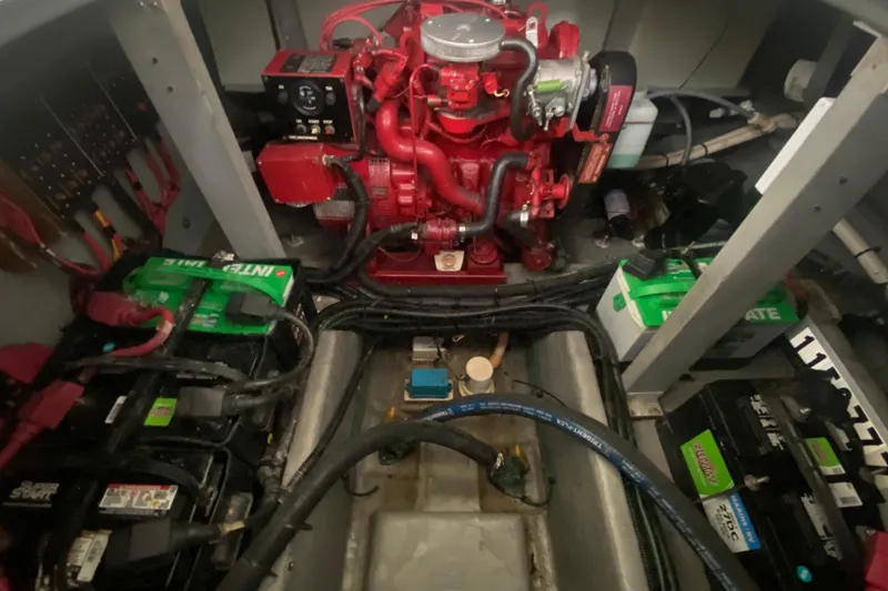 Slide: The Image of Engine room of a 1997 Sea Ray 400 Express Cruiser with visible batteries and wiring. - 35