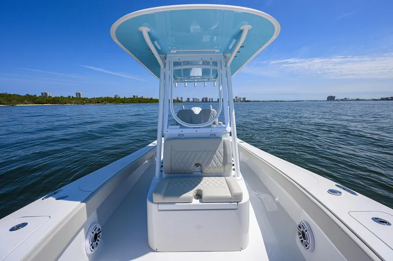 Slide: The Image of 2024 Conch 25 boat on calm water, featuring a sleek design and spacious deck. - 10