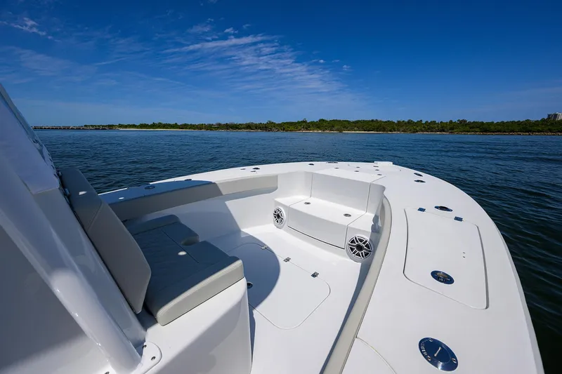 Slide: The Image of 2024 Conch 25 boat on calm water, featuring spacious seating and sleek design. - 11