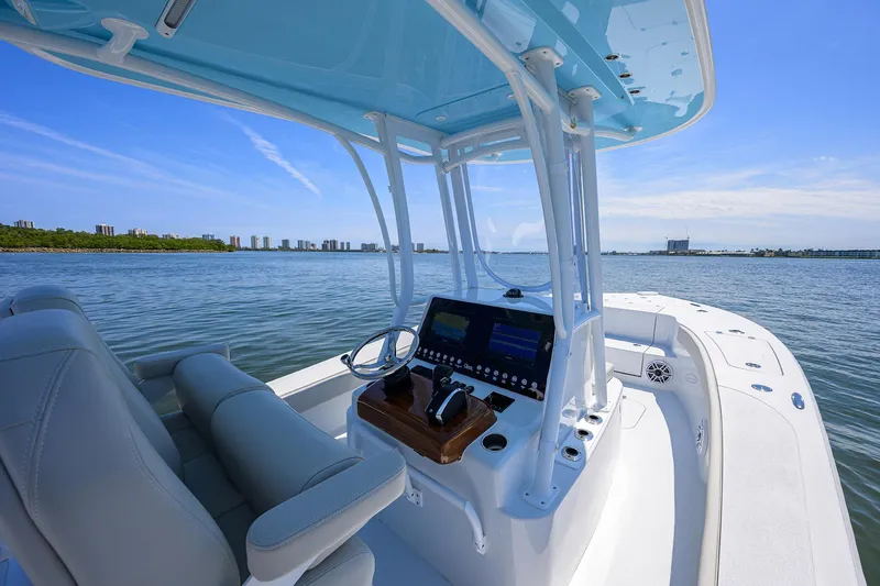 Slide: The Image of 2024 Conch 25 boat interior with modern console on calm water. - 18