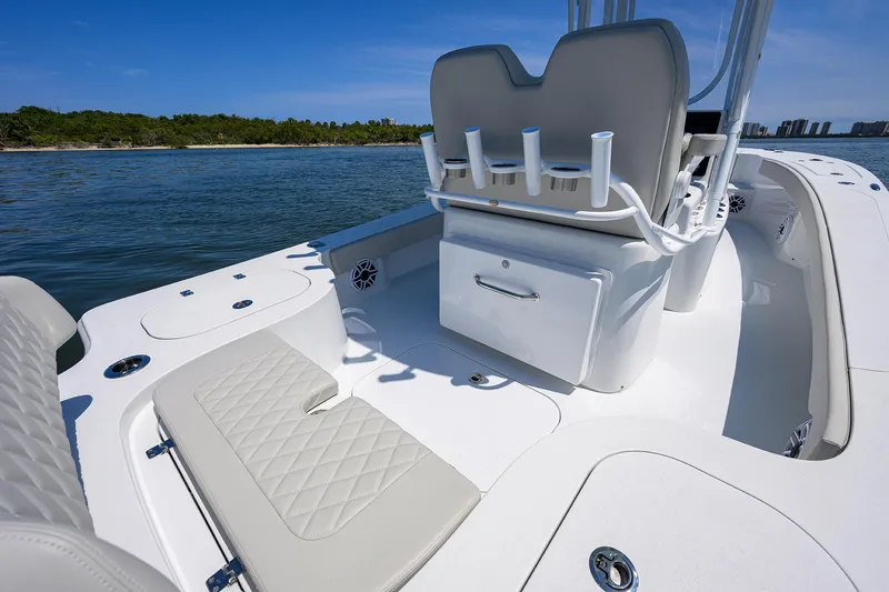 Slide: The Image of 2024 Conch 25 boat interior with seating and rod holders on a sunny day. - 19