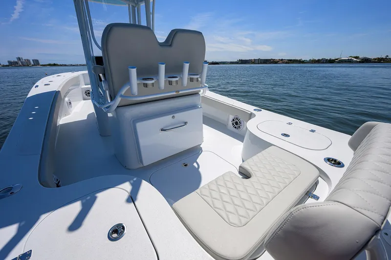 Slide: The Image of 2024 Conch 25 boat interior with seating and rod holders on a sunny day. - 21