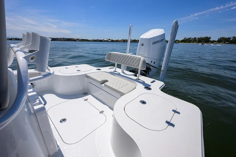 Slide: The Image of 2024 Conch 25 boat interior with seating and storage, on calm water. - 24