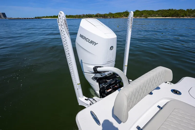 Slide: The Image of 2024 Conch 25 boat with Mercury engine on calm water. - 27