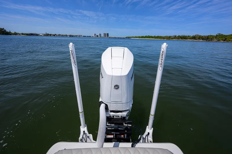 Slide: The Image of 2024 Conch 25 boat on water, rear view with motor and clear sky. - 28