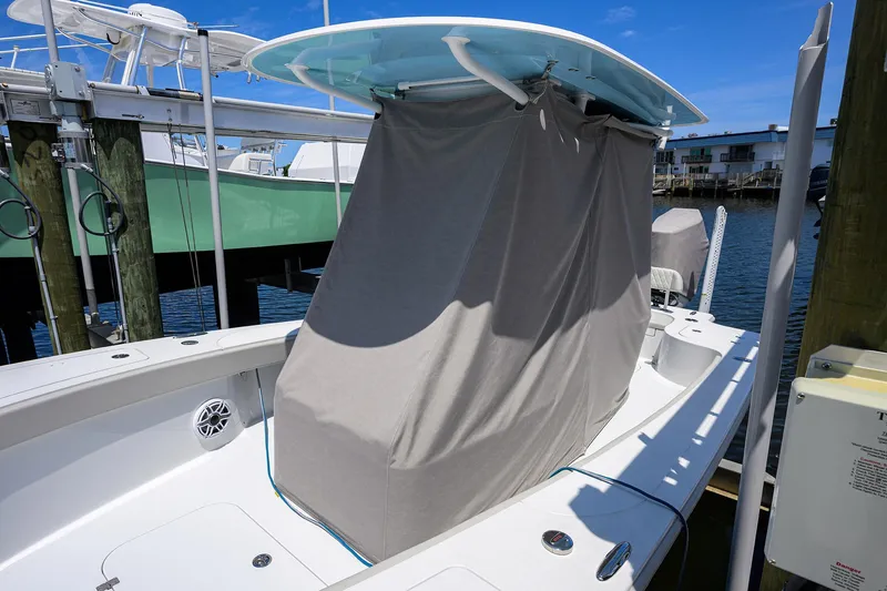 Slide: The Image of 2024 Conch 25 boat with covered console docked at marina. - 31