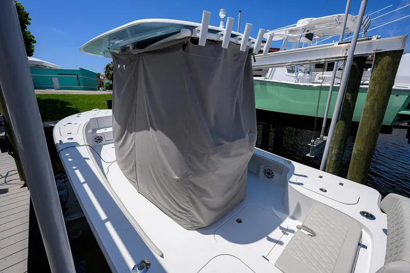 Slide: The Image of 2024 Conch 25 boat with covered center console, docked under clear blue sky. - 32