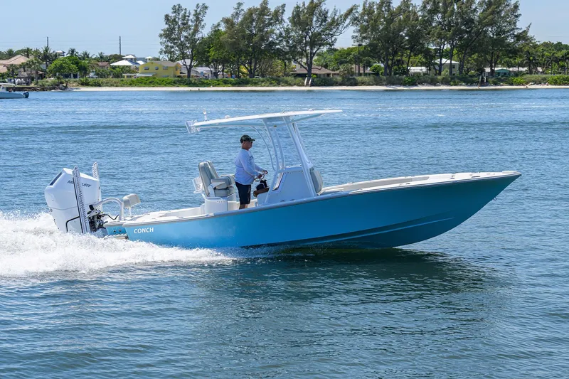 Slide: The Image of 2024 Conch 25 boat cruising on a sunny day in calm waters. - 36