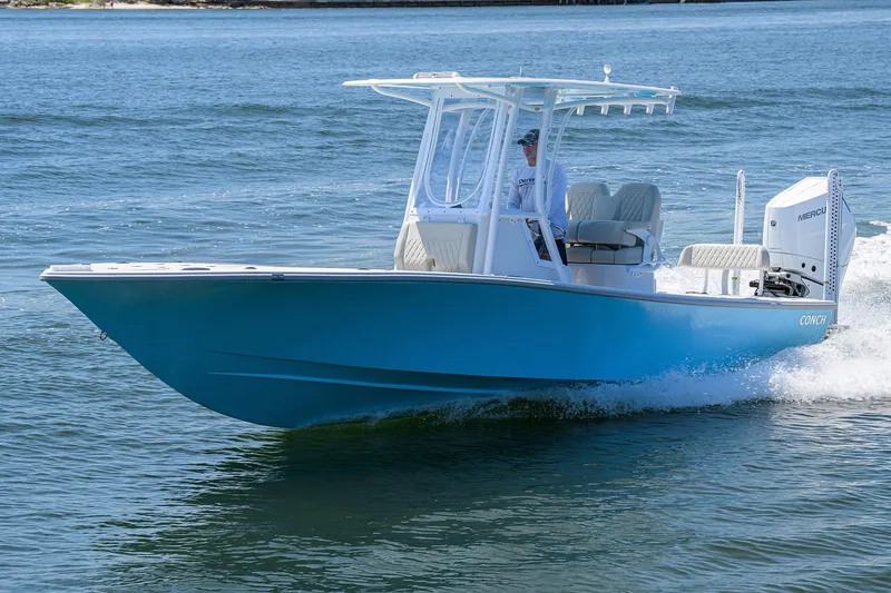 Slide: The Image of 2024 Conch 25 boat cruising on open water, featuring a sleek blue hull. - 4