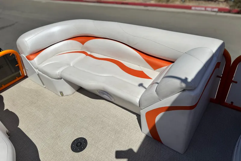 Slide: The Image of 2022 Aloha Pontoon 230 boat seating with white and orange upholstery. - 11