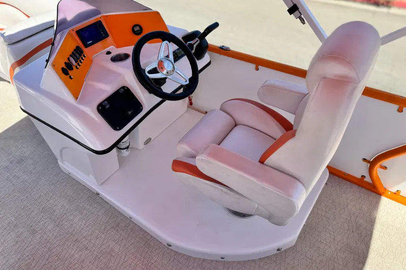 Slide: The Image of Captain's seat and helm of 2022 Aloha Pontoon 230, featuring modern controls and steering. - 19