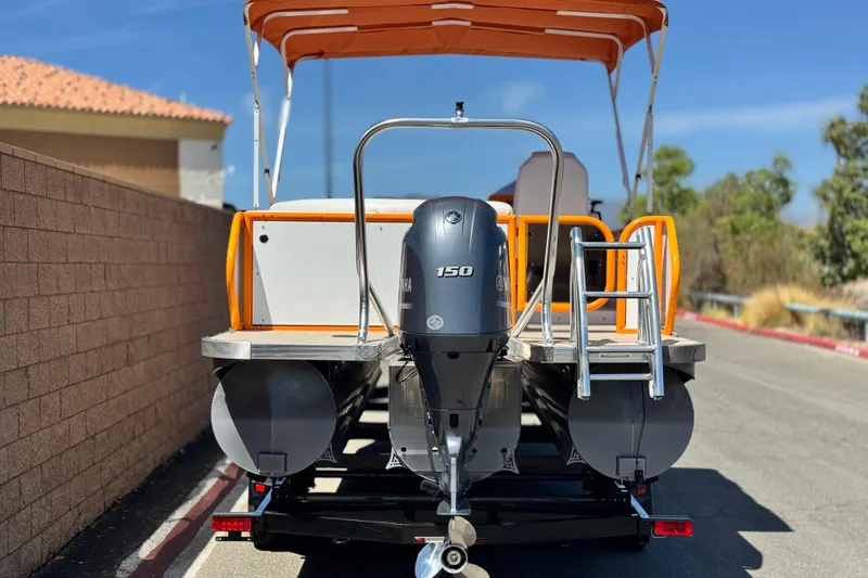 Slide: The Image of 2022 Aloha Pontoon 230 with Yamaha 150 engine, parked on a sunny day. - 5