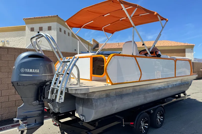 Slide: The Image of 2022 Aloha Pontoon 230 with Yamaha engine, orange canopy, and sleek design. - 6