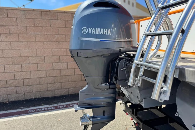 Slide: The Image of Yamaha outboard motor on 2022 Aloha Pontoon 230, parked near brick wall. - 7