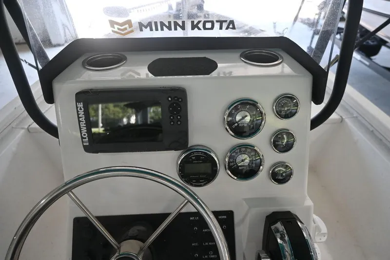 Slide: The Image of 2020 Vexus AVX1980CC boat dashboard with Lowrance display and Minn Kota branding. - 12