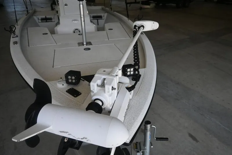 Slide: The Image of 2020 Vexus AVX1980CC boat with trolling motor in a garage setting. - 13