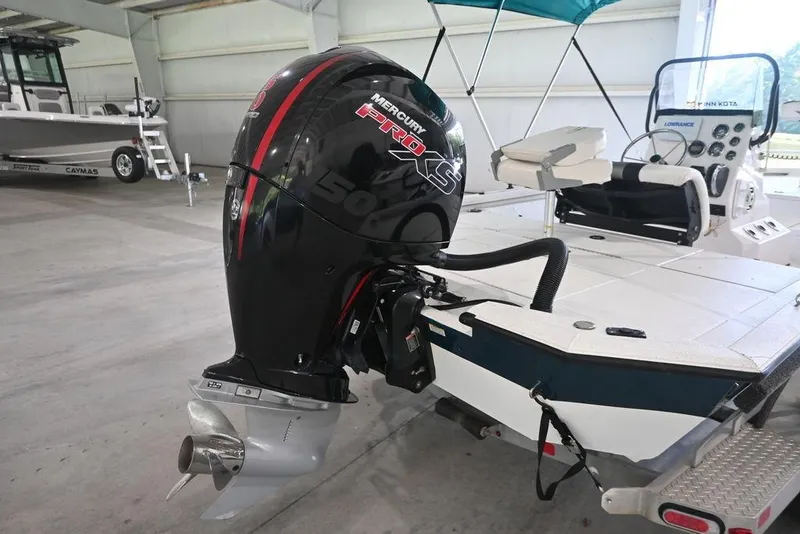 Slide: The Image of 2020 Vexus AVX1980CC boat with Mercury Pro XS outboard motor in a garage. - 3