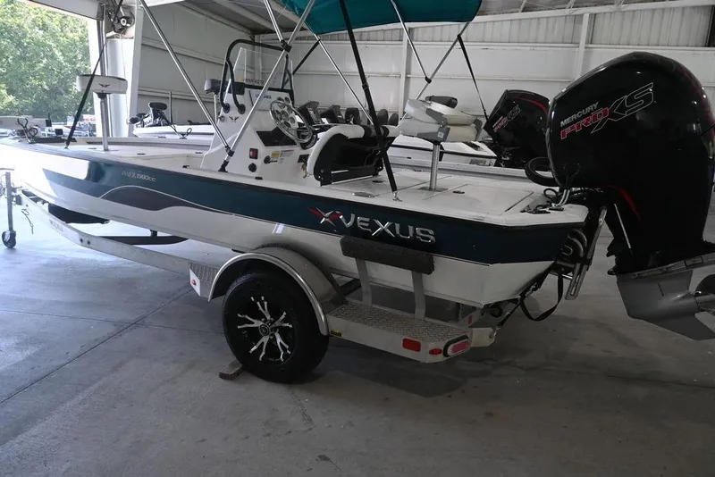 Slide: The Image of 2020 Vexus AVX1980CC boat with Mercury Pro XS engine in a garage setting. - 4