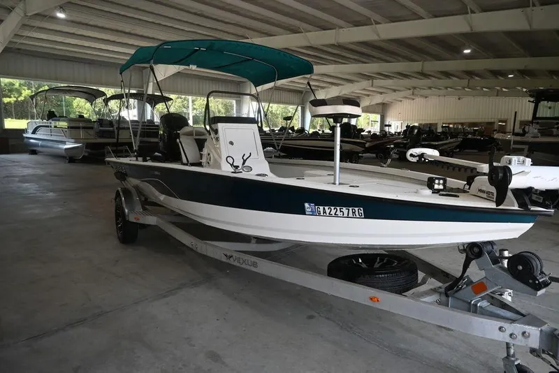 Slide: The Image of 2020 Vexus AVX1980CC boat with canopy on trailer in indoor storage. - 8
