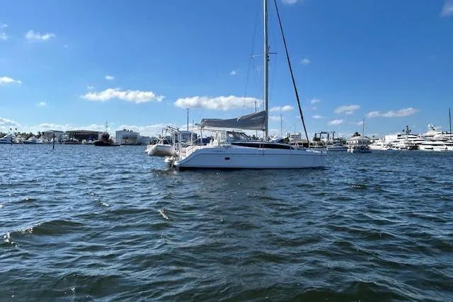 Slide: The Image of Catamaran deck on water, Gemini Legacy 2013, with visible railing and mast. - 10