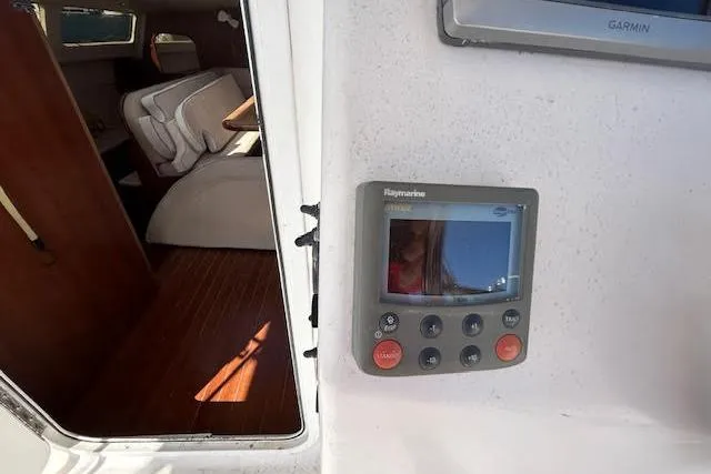 Slide: The Image of 2013 Gemini Legacy boat interior with Raymarine navigation system and wooden flooring. - 11