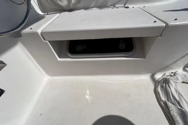 Slide: The Image of 2013 Gemini Legacy boat interior with storage compartment and seating area. - 16