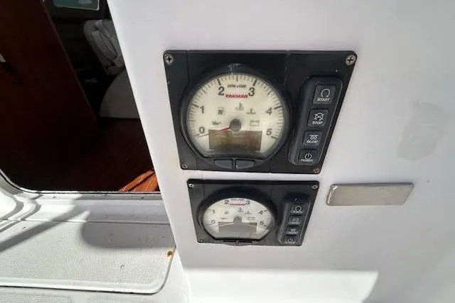 Slide: The Image of Control panel of a 2013 Gemini Legacy boat with gauges and buttons. - 18