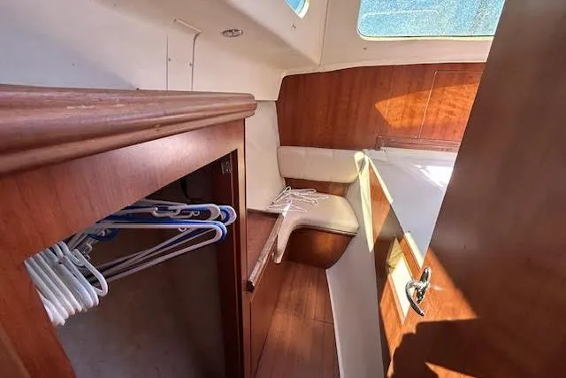 Slide: The Image of Interior of 2013 Gemini Legacy boat with wooden cabinetry and seating area. - 19