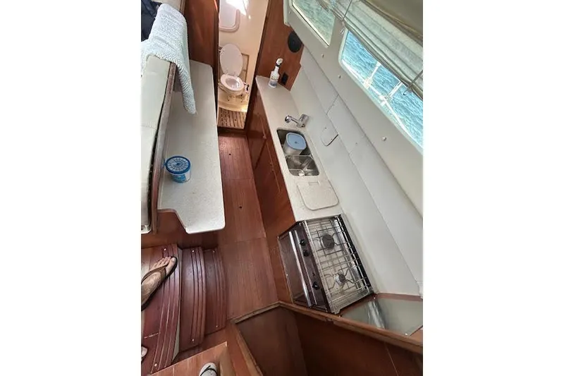Slide: The Image of Interior of 2013 Gemini Legacy boat with kitchen and seating area. - 21
