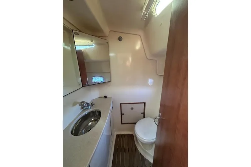 Slide: The Image of 2013 Gemini Legacy boat bathroom with sink, mirror, and toilet. - 24