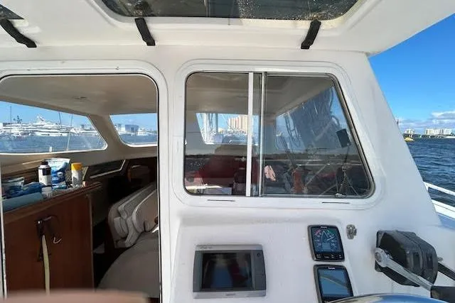 Slide: The Image of Interior view of 2013 Gemini Legacy boat with navigation equipment and ocean backdrop. - 27