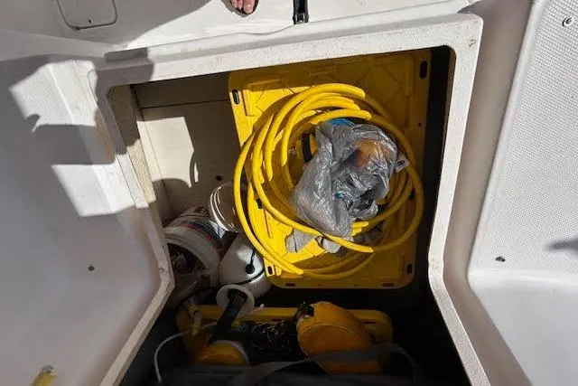 Slide: The Image of Storage compartment in 2013 Gemini Legacy boat with yellow hose and equipment. - 34