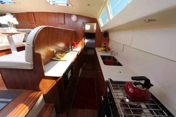 Slide: The Image of 2013 Gemini Legacy catamaran on dry dock under a partly cloudy sky. - 4