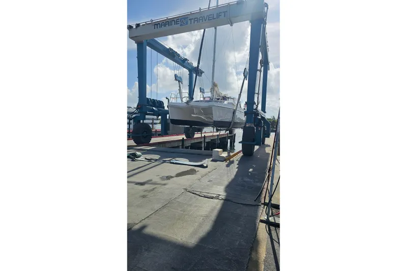 Slide: The Image of 2013 Gemini Legacy catamaran lifted by Marine Travelift at a dockside facility. - 42